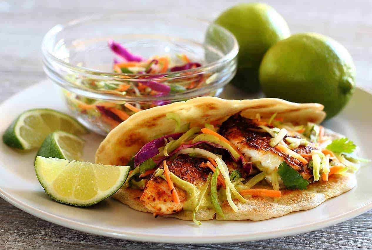 Paleo Spicy Tilapia Baja Taco with Lime Slaw and Avocado Cilantro Sauce